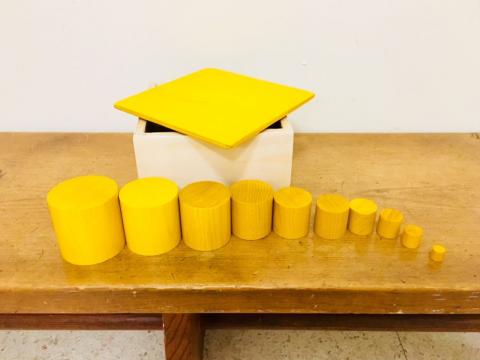 Yellow cylindrical blocks organized by height